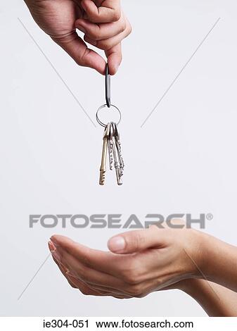Stock Image - A woman being given keys. Fotosearch