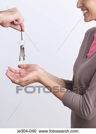 Stock Image - A woman being handed keys. Fotosearch