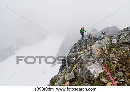 A woman climbing a mountain View Large Photo Image Picture - A woman climbing a mountain. Fotosearch