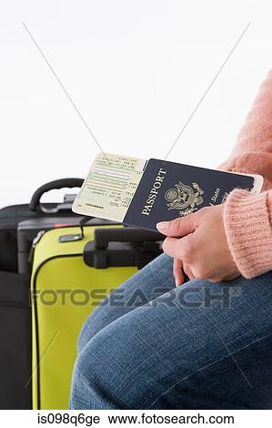 A woman holding a passport and airplane tickets View Large Photo Image Stock Image - A woman holding a passport and airplane tickets. Fotosearch