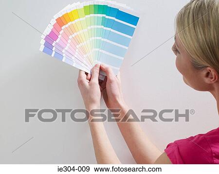 A woman looking at colour charts View Large Photo Image Stock Photo - A woman looking at colour charts. Fotosearch