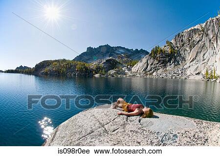 A woman sunbathing next to enchantment lakes View Large Photo Image Stock Image - A woman sunbathing next to enchantment lakes. Fotosearch