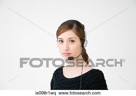 A woman wearing a telephone headset View Large Photo Image Stock Photography - A woman wearing a telephone headset. Fotosearch