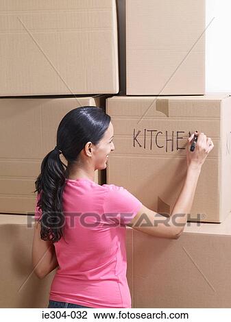 Stock Image - A woman writing on a box. Fotosearch