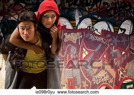 A young man giving his girlfriend a piggyback View Large Photo Image Stock Photograph - A young man giving his girlfriend a piggyback. Fotosearch