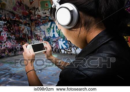 A young man playing on a handheld computer View Large Photo Image Picture - A young man playing on a handheld computer. Fotosearch