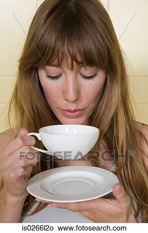 A young woman having a cup of tea View Large Photo Image Picture - A young woman having a cup of tea. Fotosearch