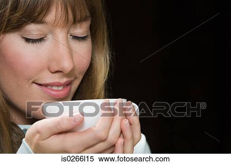 A young woman having a cup of tea View Large Photo Image Stock Photography - A young woman having a cup of tea. Fotosearch