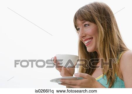 A young woman having a cup of tea View Large Photo Image Stock Photography - A young woman having a cup of tea. Fotosearch