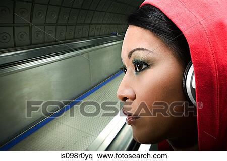 A young woman listening to music View Large Photo Image Stock Photography - A young woman listening to music. Fotosearch