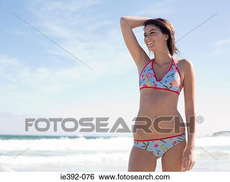 A young woman on a beach View Large Photo Image Stock Photograph - A young woman on a beach. Fotosearch