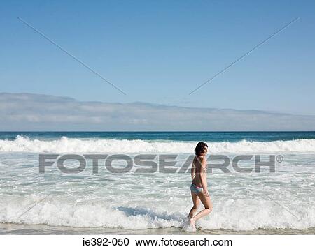 A young woman running in the sea View Large Photo Image Stock Image - A young woman running in the sea. Fotosearch