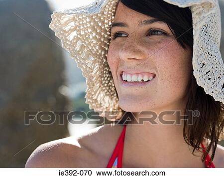 Stock Image - A young woman wearing a hat. Fotosearch