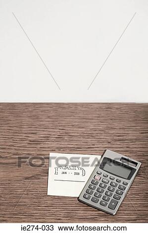 Stock Image - Adhesive note and calculator. Fotosearch