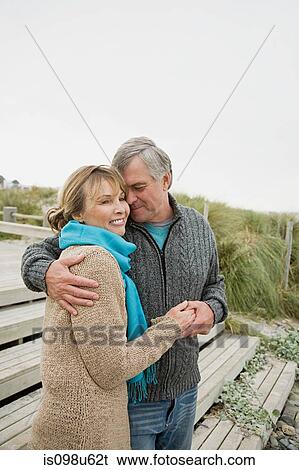 Affectionate couple at the coast View Large Photo Image Stock Photograph - Affectionate couple at the coast. Fotosearch