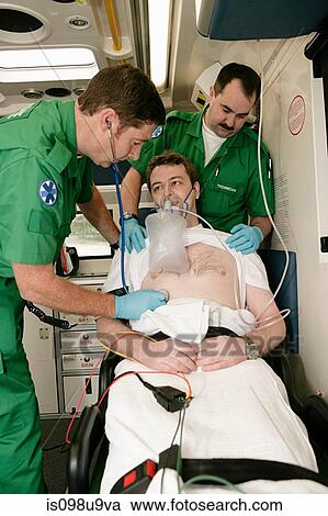 Ambulance technicians caring for patient View Large Photo Image Stock Image - Ambulance technicians caring for patient. Fotosearch