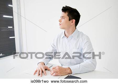 An office worker thinking View Large Photo Image Picture - An office worker thinking. Fotosearch