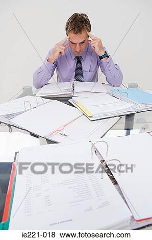 An overworked businessman View Large Photo Image Stock Photo - An overworked businessman. Fotosearch