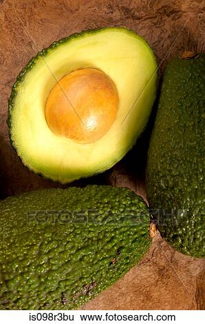Avocados on textured background View Large Photo Image Stock Photograph - Avocados on textured background. Fotosearch