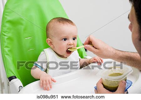 Baby being fed View Large Photo Image Stock Image - Baby being fed. Fotosearch
