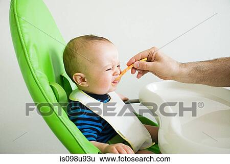 Baby being fed View Large Photo Image Stock Photograph - Baby being fed. Fotosearch