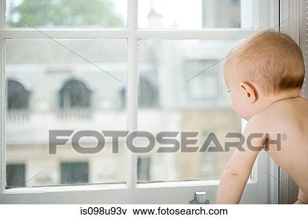 Stock Photo - Baby looking out of window. Fotosearch