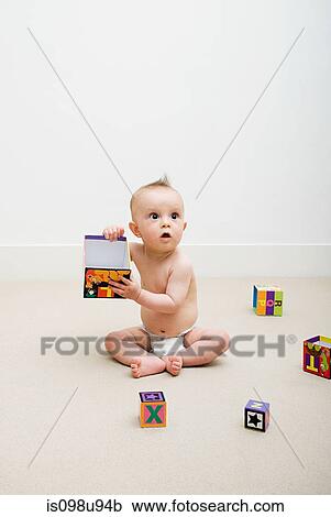 Stock Image - Baby playing with toy blocks. Fotosearch