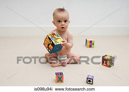 Baby playing with toy blocks View Large Photo Image Stock Image - Baby playing with toy blocks. Fotosearch