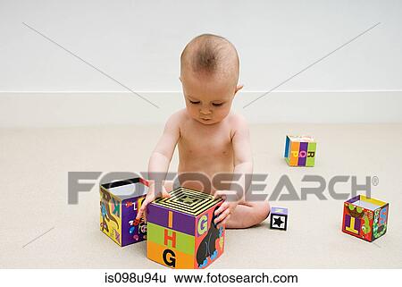 Stock Photograph - Baby playing with toy blocks. Fotosearch