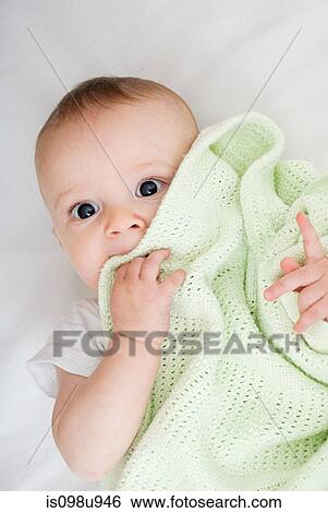 Stock Photograph - Baby with blanket. Fotosearch