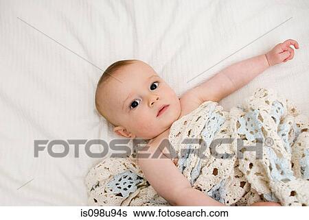 Stock Photograph - Baby with blanket. Fotosearch