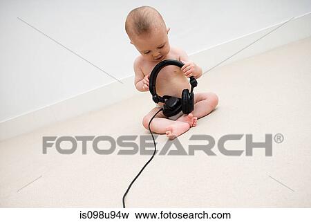 Baby with head phones View Large Photo Image Stock Photo - Baby with head phones. Fotosearch