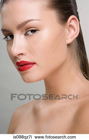 Stock Image - Beautiful woman wearing red lipstick. Fotosearch