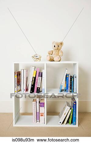 Picture - Bookshelf with books and toys. Fotosearch