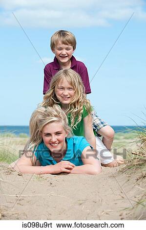 Boy and girl sitting on older sister View Large Photo Image Stock Photograph - Boy and girl sitting on older sister. Fotosearch