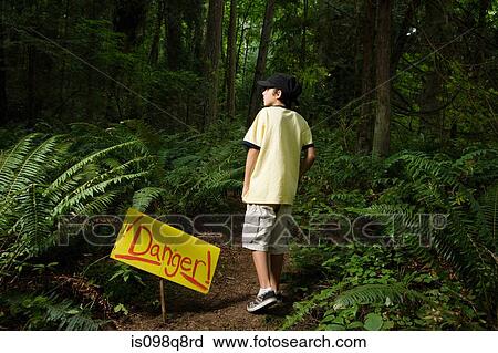 Boy by danger sign View Large Photo Image Stock Image - Boy by danger sign. Fotosearch