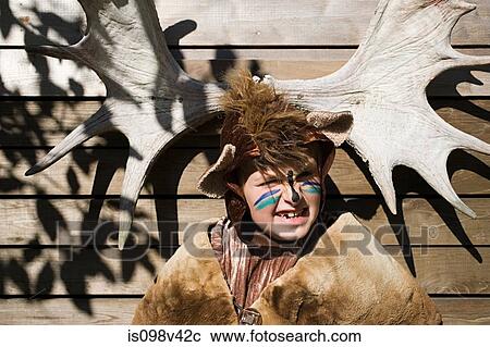 Boy dressed up as bear in front of moose antlers View Large Photo Image Stock Image - Boy dressed up as bear in front of moose antlers. Fotosearch