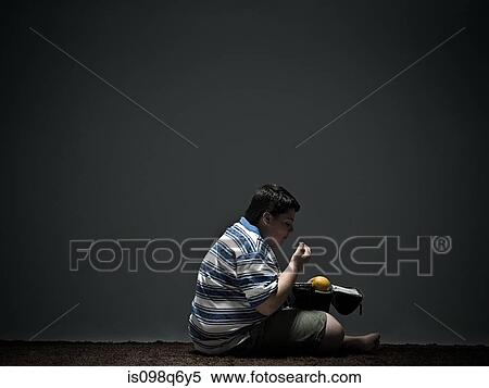 Boy eating packed lunch View Large Photo Image Stock Photography - Boy eating packed lunch. Fotosearch