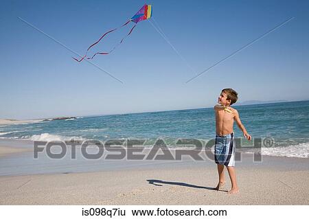 Boy flying kite View Large Photo Image Stock Photograph - Boy flying kite. Fotosearch