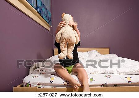 Stock Photo - Boy holding a teddy. Fotosearch