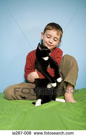 Boy holding pet cat View Large Photo Image Stock Photo - Boy holding pet cat. Fotosearch