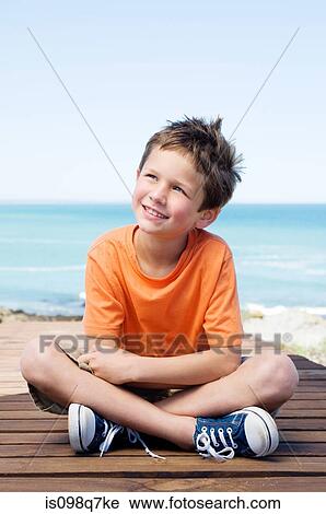 Stock Image - Boy looking up. Fotosearch