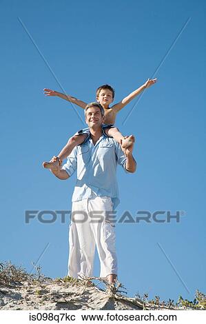 Boy on fathers shoulders View Large Photo Image Stock Image - Boy on fathers shoulders. Fotosearch