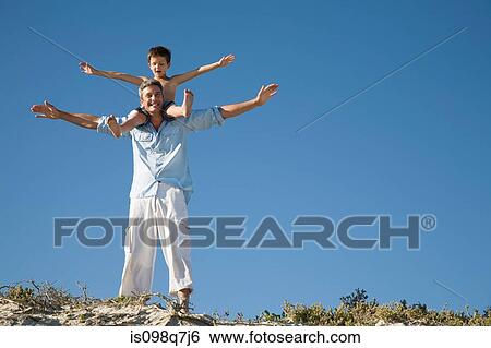 Stock Photograph - Boy on fathers shoulders. Fotosearch