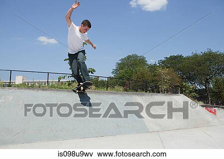 Boy on skateboard jumping off ramp View Large Photo Image Stock Photo - Boy on skateboard jumping off ramp. Fotosearch