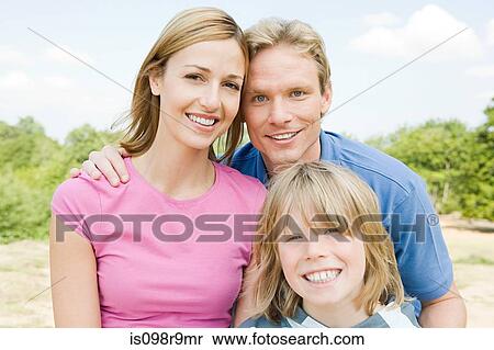 Stock Photography - Boy outdoors with parents. Fotosearch