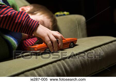 Boy playing with a toy car View Large Photo Image Stock Photography - Boy playing with a toy car. Fotosearch