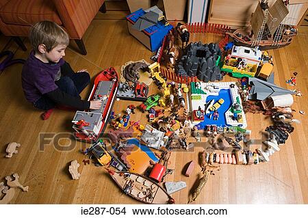 Picture - Boy playing with large collection of toys. Fotosearch