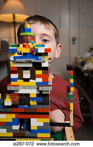 Stock Image - Boy playing with plastic blocks. Fotosearch