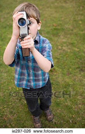 Stock Photograph - Boy using a video camera. Fotosearch
